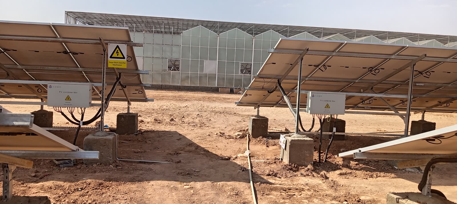 Combiner boxes beside the greenhouses